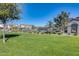 Community pool with grassy area and trees at 1255 N Arizona Ave # 1276, Chandler, AZ 85225