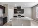 Modern kitchen with granite island and dark cabinets at 1255 N Arizona Ave # 1276, Chandler, AZ 85225