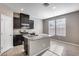 Modern kitchen with granite island and dark cabinets at 1255 N Arizona Ave # 1276, Chandler, AZ 85225
