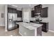 Modern kitchen with dark cabinets, granite island, and stainless steel appliances at 1255 N Arizona Ave # 1276, Chandler, AZ 85225