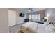 Primary bedroom with king bed, twin bed, and bay window with plantation shutters at 15420 N 160Th Ln, Surprise, AZ 85374