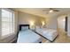 Primary bedroom with a king bed and twin bed, and ceiling fan at 15420 N 160Th Ln, Surprise, AZ 85374