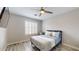 Bright bedroom with a queen bed, wood floors, and plantation shutters at 15420 N 160Th Ln, Surprise, AZ 85374
