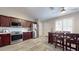 Modern kitchen with dark wood cabinets, stainless steel appliances, and a breakfast bar at 15420 N 160Th Ln, Surprise, AZ 85374