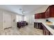 Kitchen with dark wood cabinets, stainless steel appliances and breakfast bar at 15420 N 160Th Ln, Surprise, AZ 85374