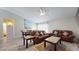 Living room with hardwood floors, a brown leather sectional sofa and a dining area at 15420 N 160Th Ln, Surprise, AZ 85374