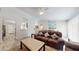 Open living room with a view into the kitchen and a brown leather couch at 15420 N 160Th Ln, Surprise, AZ 85374