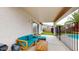 Covered patio with seating and access to backyard pool at 15420 N 160Th Ln, Surprise, AZ 85374