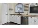 White kitchen cabinets, butcher block countertops, and stainless steel dishwasher at 1610 N Stapley Dr # 104, Mesa, AZ 85203