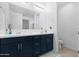 Double vanity bathroom with navy cabinets and a spacious layout at 1793 N Westfall Ln, Casa Grande, AZ 85122