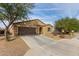 Single-story home with a two-car garage and desert landscaping at 20056 W Jackson St, Buckeye, AZ 85326