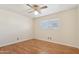 Simple bedroom with hardwood floors and window at 203 W Llano Dr, Litchfield Park, AZ 85340