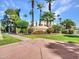 Wigwam community entrance with lush landscaping and palm trees at 203 W Llano Dr, Litchfield Park, AZ 85340