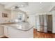 Modern kitchen with stainless steel appliances and white cabinets at 203 W Llano Dr, Litchfield Park, AZ 85340