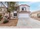 Two-story house with a white exterior, two-car garage, and landscaping at 23957 W Tonto St, Buckeye, AZ 85326