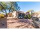 Landscaped front yard with mature trees and desert plants at 2443 N Trenton --, Mesa, AZ 85207