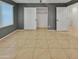Bedroom with tile floor, closet, and window at 2522 W Brisa Dr, Phoenix, AZ 85085