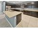 Modern kitchen features dark cabinetry, stainless steel appliances, and an island at 2522 W Brisa Dr, Phoenix, AZ 85085