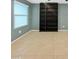 Bright living room featuring built-in shelving and tile floors at 2522 W Brisa Dr, Phoenix, AZ 85085