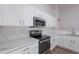 Modern kitchen with white cabinets, stainless steel appliances, and quartz countertops at 3113 E Bellerive Dr, Chandler, AZ 85249