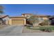 Two-story house with stone accents, landscaped lawn, and a two-car garage at 5322 W Coles Rd, Laveen, AZ 85339