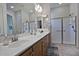 Double vanity bathroom with large mirror and shower at 5657 W Cinder Brook N Way, Florence, AZ 85132