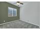 Bright bedroom with grey carpet and two-toned walls at 6413 W Copper Springs Rd, Phoenix, AZ 85083