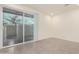 Bright interior room with sliding glass door leading to a patio at 6850 E Mcdowell Rd # 26, Scottsdale, AZ 85257
