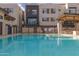 Community pool and spa with lounge chairs and BBQ area at 6850 E Mcdowell Rd # 26, Scottsdale, AZ 85257