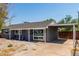 Gray house with carport, colorful chairs, and rock landscaping at 7039 E Virginia Ave, Scottsdale, AZ 85257