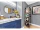 Stylish bathroom with navy vanity, white countertop, and a black metal cabinet at 7161 E Rancho Vista Dr # 3001, Scottsdale, AZ 85251