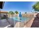 Sparkling pool with safety fence and grassy area at 7244 E Olla Ave, Mesa, AZ 85212