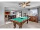 Game room features a pool table, dining table, and view into the kitchen at 7323 E Lewis Ave, Scottsdale, AZ 85257