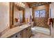Bathroom with bathtub, toilet, vanity, and tiled walls at 10040 E Happy Valley Rd # 2046, Scottsdale, AZ 85255