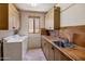 Laundry room with washer, dryer, sink, and cabinets at 10040 E Happy Valley Rd # 2046, Scottsdale, AZ 85255