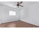 Bright bedroom with wood floors, ceiling fan, and large closet at 12820 N 29Th Dr, Phoenix, AZ 85029