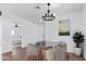 Elegant dining area with chandelier and four chairs at 12820 N 29Th Dr, Phoenix, AZ 85029