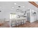 Modern kitchen with island, stainless steel appliances, and white cabinets at 12820 N 29Th Dr, Phoenix, AZ 85029