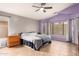 Main bedroom with tiled floors, large windows and ceiling fan at 15206 N 134Th Ln, Surprise, AZ 85379