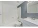 Clean bathroom with white bathtub and gray walls at 1920 W Lindner Ave # 147, Mesa, AZ 85202