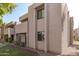 Side view of tan condo building showcasing windows and landscaping at 1920 W Lindner Ave # 147, Mesa, AZ 85202