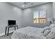 Bedroom featuring a bed, TV, and window with blinds at 21934 E Stone Crest Ct, Queen Creek, AZ 85142