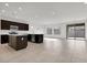 Open kitchen with island, dark cabinets, and tile floor at 2518 N Pony Ln, Casa Grande, AZ 85122