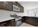 Stainless steel appliances and dark brown cabinets in this modern kitchen at 2518 N Pony Ln, Casa Grande, AZ 85122