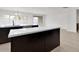 Kitchen island with white countertop and dark brown cabinets at 2518 N Pony Ln, Casa Grande, AZ 85122