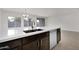 Kitchen island with double sink, dishwasher, and white countertop at 2518 N Pony Ln, Casa Grande, AZ 85122