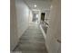 Bright hallway with gray vinyl plank flooring and multiple doors at 2647 S Athena --, Mesa, AZ 85209