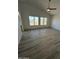 Bright living room with large windows and gray vinyl plank flooring at 2647 S Athena --, Mesa, AZ 85209