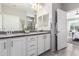 Elegant bathroom with a double vanity, granite countertops, and a walk-in shower at 26653 W Firehawk Dr, Buckeye, AZ 85396