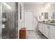 Double vanity bathroom with a walk-in shower and granite countertops at 26653 W Firehawk Dr, Buckeye, AZ 85396